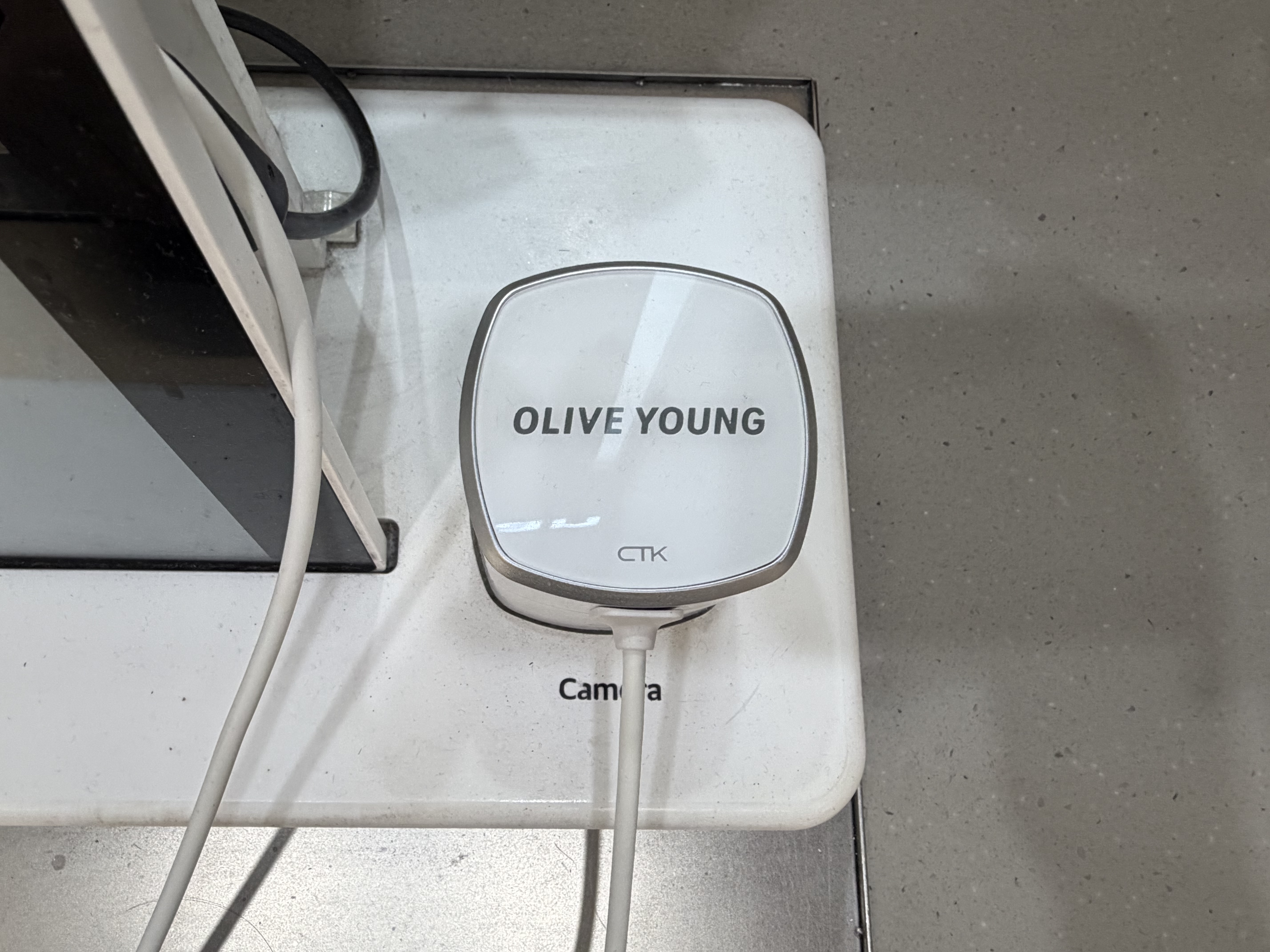 Close-up of a skin analyzer camera device used in an Olive Young Skin Scan station